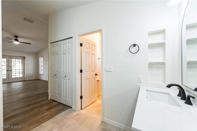 bathroom featuring ceiling fan, french doors, vanity, and wood-type flooring