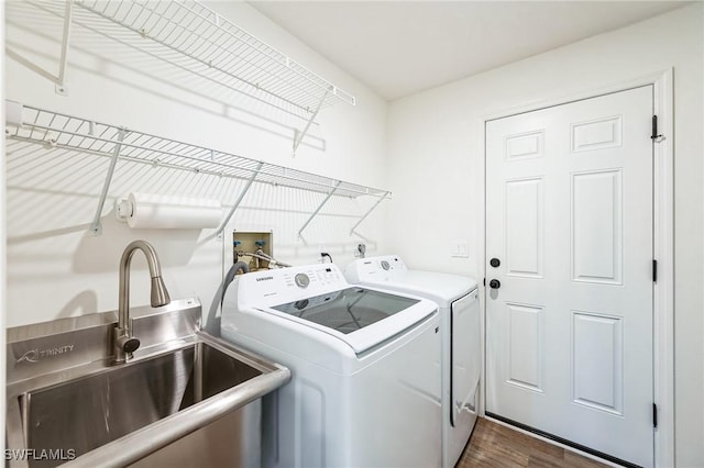 laundry room featuring separate washer and dryer, sink, and dark hardwood / wood-style floors