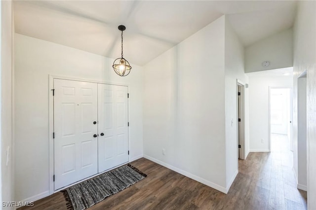 entrance foyer with dark hardwood / wood-style flooring and vaulted ceiling