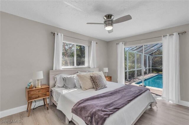 bedroom with a textured ceiling, light wood-type flooring, access to outside, and ceiling fan