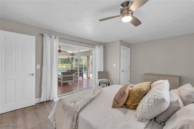 bedroom featuring access to exterior, a textured ceiling, light wood-type flooring, and ceiling fan