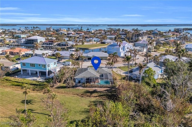 drone / aerial view featuring a residential view and a water view