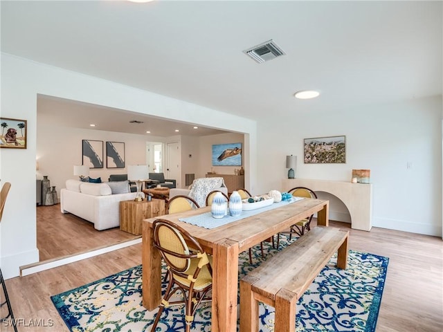 dining space with light hardwood / wood-style floors