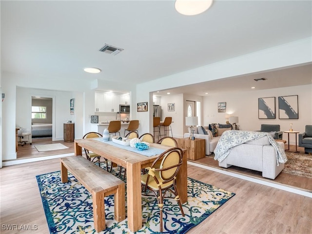 dining space featuring light hardwood / wood-style flooring