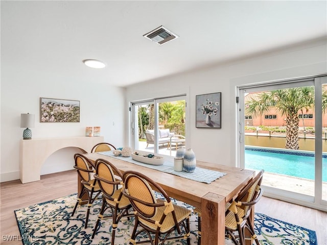 dining space with light wood-type flooring