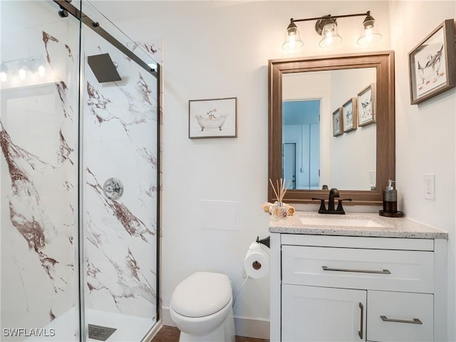 bathroom featuring vanity, toilet, and a shower with door