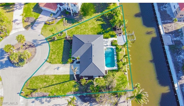 birds eye view of property with a water view