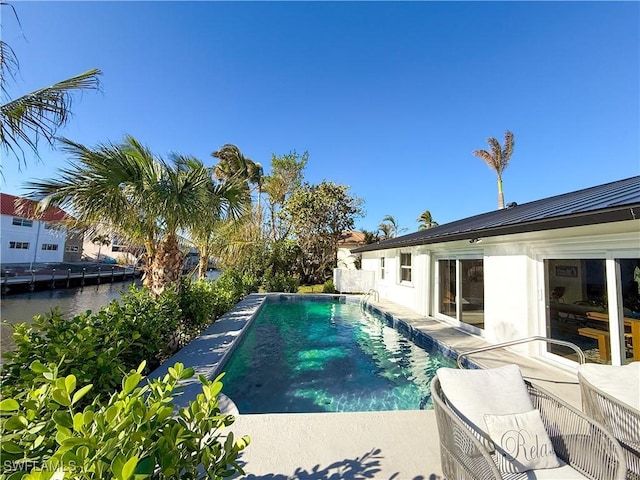 view of swimming pool with a water view