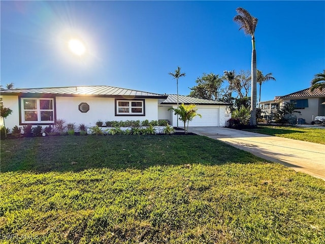 single story home featuring a garage and a front lawn