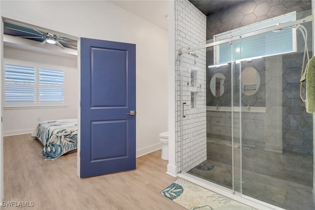 bathroom with hardwood / wood-style floors, lofted ceiling, ceiling fan, toilet, and walk in shower