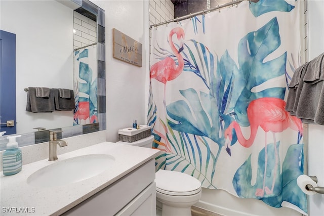 full bathroom with vanity, shower / bath combo, and toilet