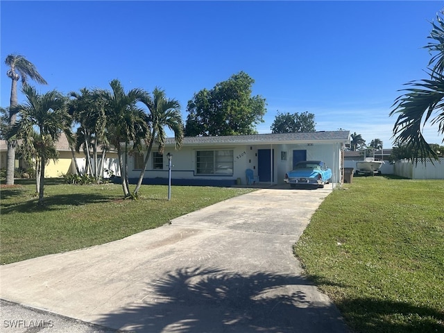 ranch-style home with a carport and a front lawn