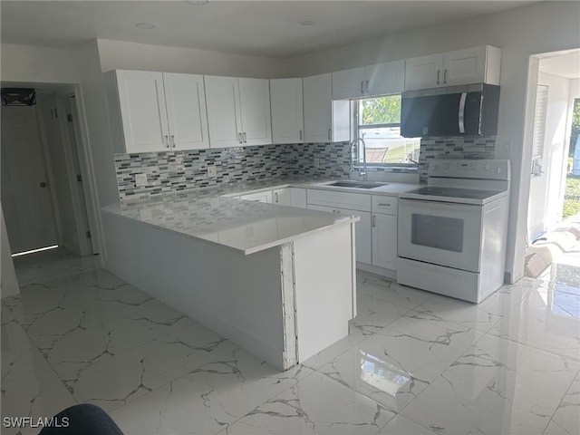 kitchen featuring kitchen peninsula, decorative backsplash, sink, electric stove, and white cabinetry