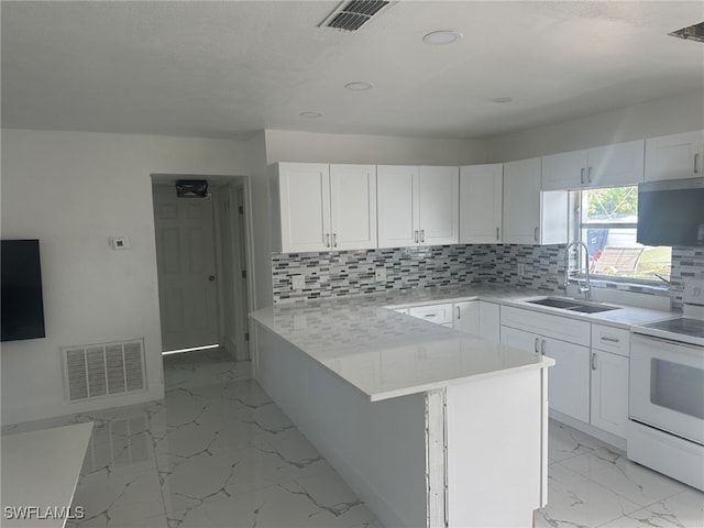 kitchen with decorative backsplash, stove, white cabinets, and sink