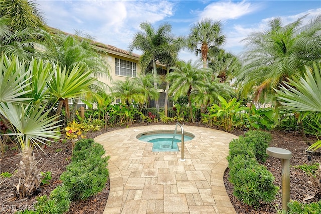 view of swimming pool with an in ground hot tub