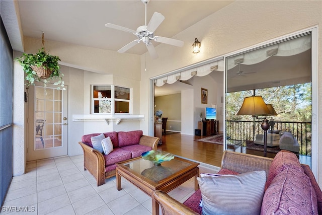 living room with ceiling fan and light tile patterned floors