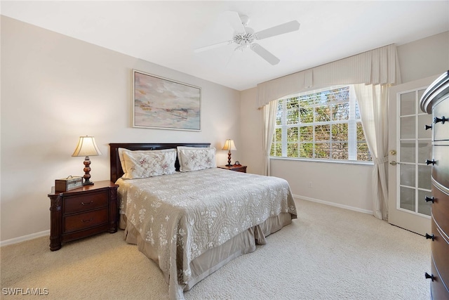 bedroom featuring ceiling fan and light carpet