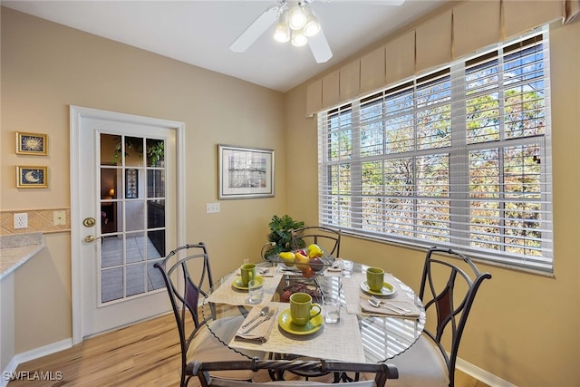 dining area featuring light wood-type flooring and ceiling fan