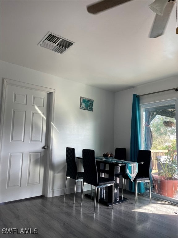 dining area with ceiling fan and dark hardwood / wood-style flooring