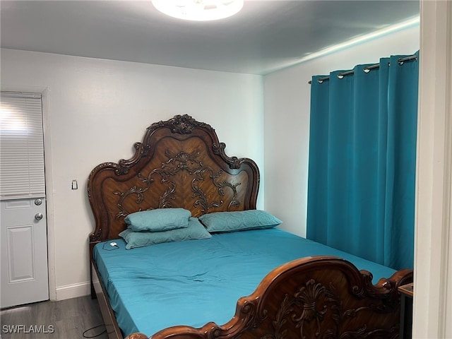 bedroom with wood-type flooring