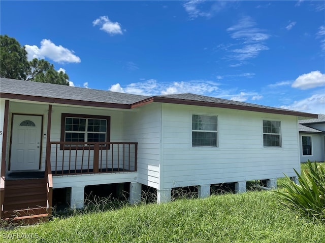 rear view of property with a porch