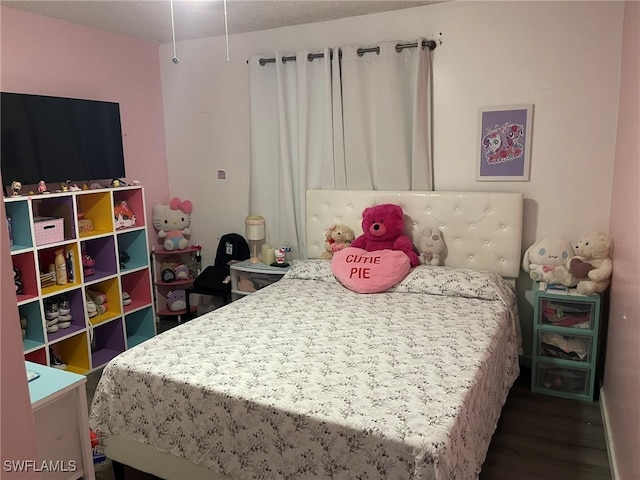 bedroom with dark wood-type flooring