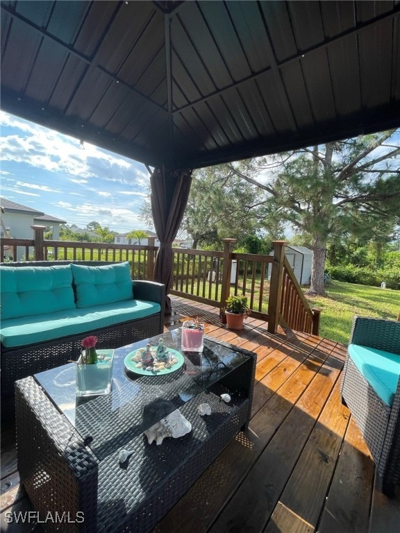 deck featuring outdoor lounge area, a gazebo, and a storage shed