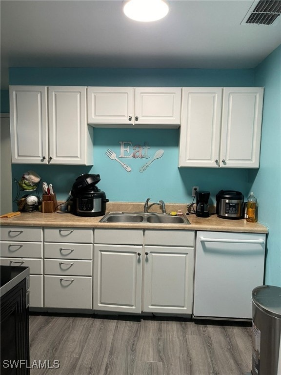 kitchen with dishwasher, white cabinetry, sink, and dark wood-type flooring