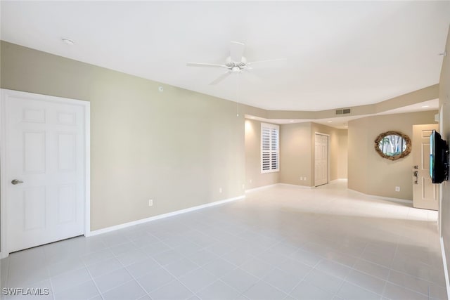 tiled empty room with ceiling fan