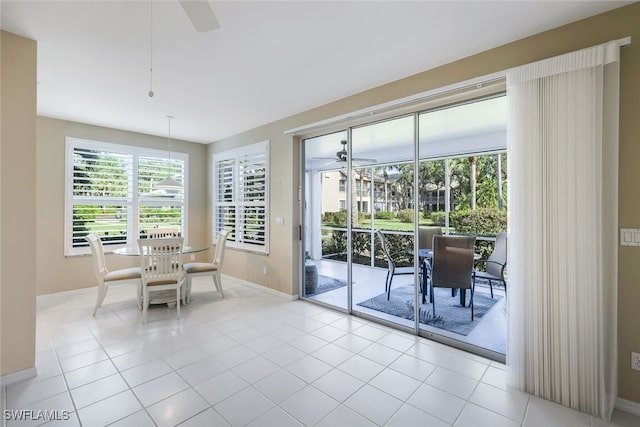 unfurnished dining area with ceiling fan and light tile patterned flooring