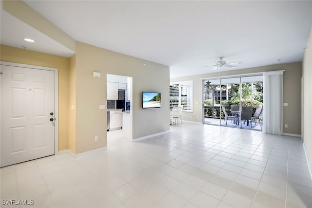 tiled empty room featuring ceiling fan