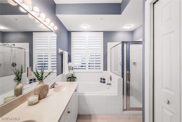 bathroom with tile patterned flooring, vanity, and plus walk in shower