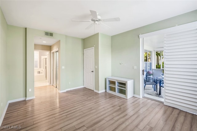 unfurnished room with light wood-type flooring and ceiling fan