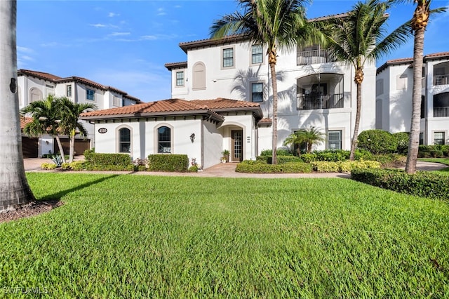 mediterranean / spanish house featuring a front yard