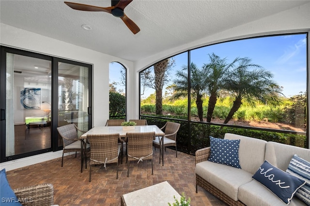 sunroom / solarium featuring ceiling fan