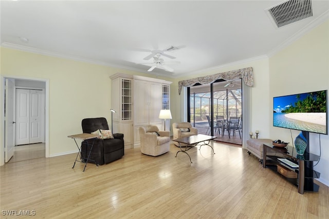 living room with crown molding, light hardwood / wood-style flooring, and ceiling fan