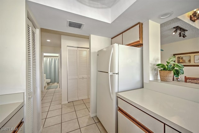 kitchen featuring white fridge and light tile patterned floors