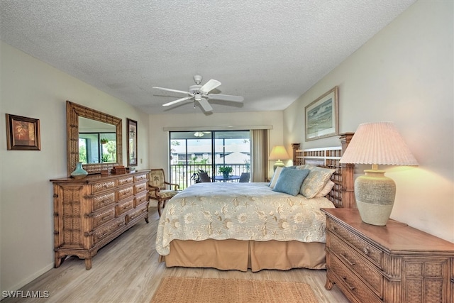 bedroom with a textured ceiling, access to outside, light hardwood / wood-style flooring, and ceiling fan