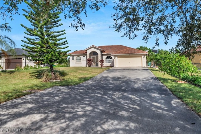 view of front of house with a garage and a front yard