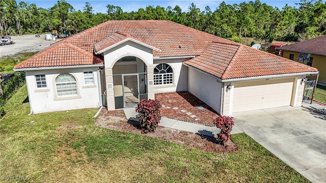 view of front of home with a front yard and a garage