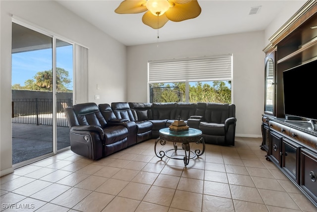 living room featuring plenty of natural light, ceiling fan, and light tile patterned floors