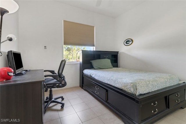 tiled bedroom featuring ceiling fan