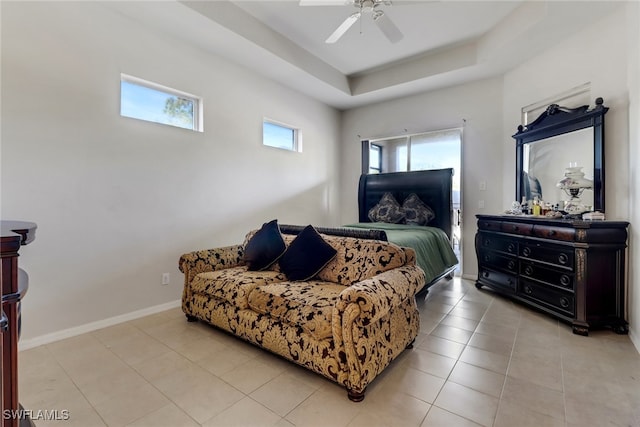 bedroom with light tile patterned floors, a raised ceiling, and ceiling fan