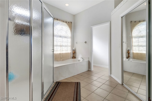 bathroom featuring tile patterned flooring and plus walk in shower