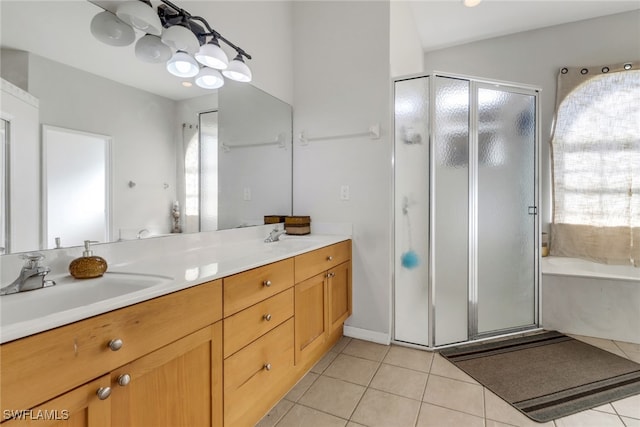 bathroom featuring tile patterned floors, vanity, and shower with separate bathtub