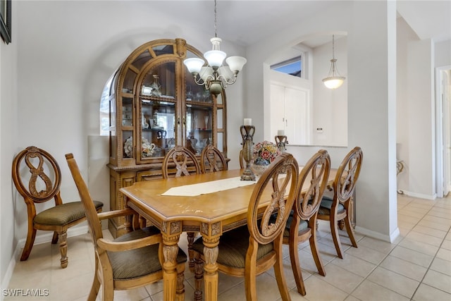 tiled dining space with a notable chandelier