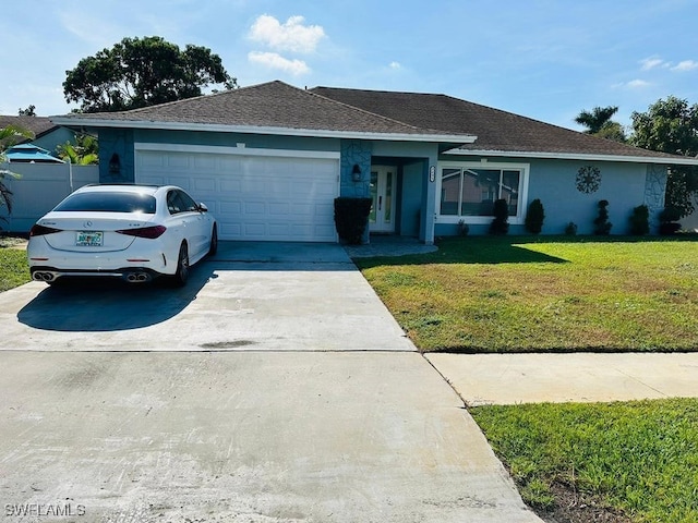 ranch-style house featuring a garage and a front lawn