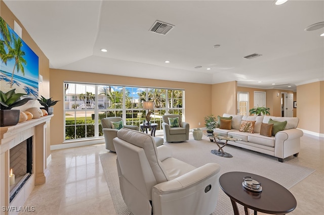 living room featuring light tile patterned flooring and ornamental molding