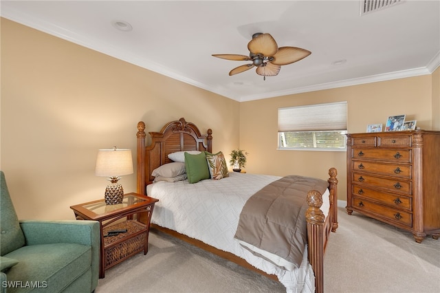 carpeted bedroom featuring ceiling fan and ornamental molding