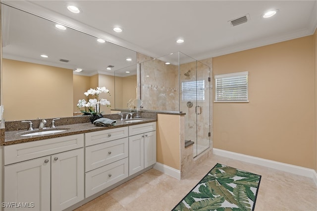 bathroom with crown molding, vanity, and a shower with shower door